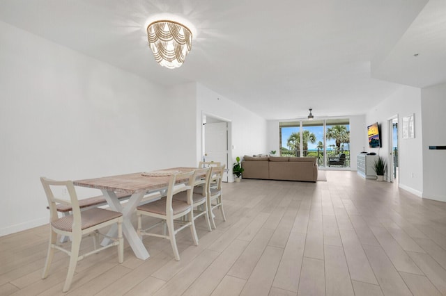 120 Ocean Grande Blvd Unit 302, Jupiter, FL 33477 - dining space featuring a chandelier, light wood-style flooring, and ceiling fan