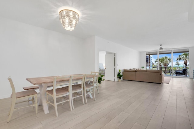 120 Ocean Grande Blvd Unit 302, Jupiter, FL 33477 - dining space with light wood-style flooring, a chandelier, and a ceiling fan