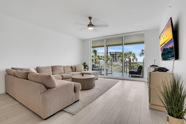 120 Ocean Grande Blvd Unit 302, Jupiter, FL 33477 - living room featuring floor to ceiling windows, ceiling fan, and light wood-style floors