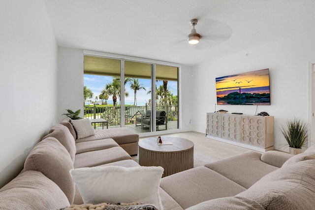 120 Ocean Grande Blvd Unit 302, Jupiter, FL 33477 - living area featuring ceiling fan, expansive windows, and wood finished floors