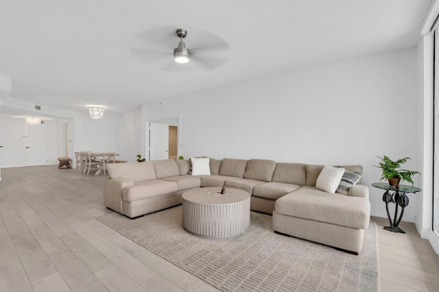 120 Ocean Grande Blvd Unit 302, Jupiter, FL 33477 - living area featuring ceiling fan, light wood-type flooring, and a chandelier