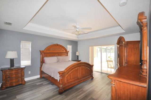 6771 NW Daffodil Ln, Port Saint Lucie, FL 34983 - bedroom featuring a tray ceiling, wood finished floors, ornamental molding, and a ceiling fan