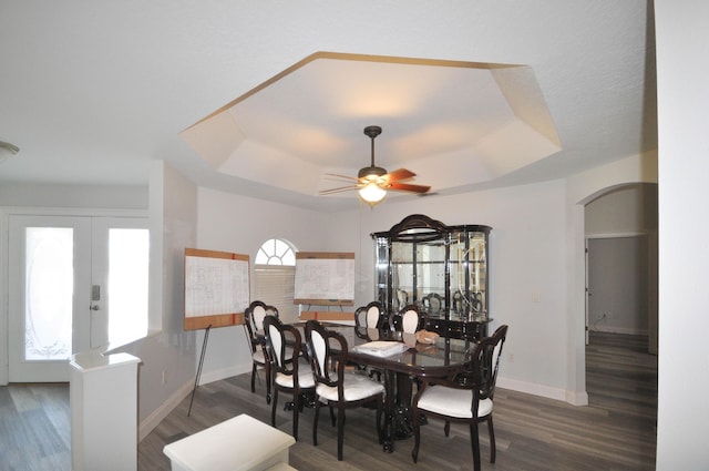 6771 NW Daffodil Ln, Port Saint Lucie, FL 34983 - dining area with a raised ceiling, a ceiling fan, wood finished floors, and arched walkways