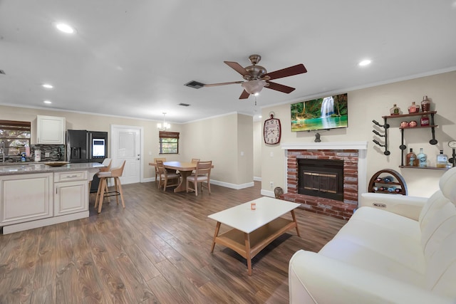 1966 9th St, Vero Beach, FL 32960 - living area with a ceiling fan, wood finished floors, recessed lighting, crown molding, and a fireplace