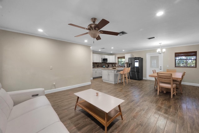1966 9th St, Vero Beach, FL 32960 - living room with a chandelier, recessed lighting, crown molding, light wood-style floors, and ceiling fan