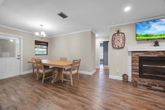 1966 9th St, Vero Beach, FL 32960 - dining space featuring a chandelier, wood finished floors, ornamental molding, recessed lighting, and a brick fireplace