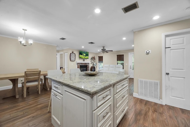 1966 9th St, Vero Beach, FL 32960 - kitchen with a fireplace, ceiling fan, crown molding, recessed lighting, and open floor plan