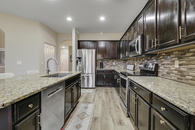 244 Behring Way, Jupiter, FL 33458 - kitchen featuring appliances with stainless steel finishes, light wood-type flooring, light stone counters, backsplash, and recessed lighting