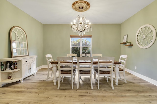 244 Behring Way, Jupiter, FL 33458 - dining area with light wood-style flooring and a chandelier