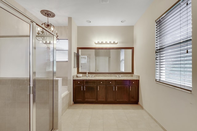 244 Behring Way, Jupiter, FL 33458 - bathroom with tile patterned floors, a chandelier, double vanity, a garden tub, and a stall shower