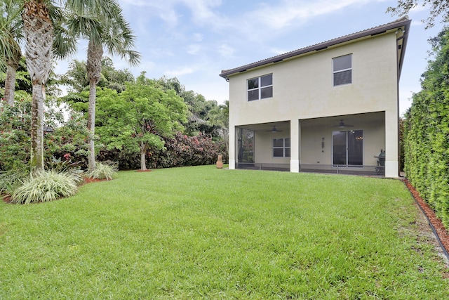 244 Behring Way, Jupiter, FL 33458 - rear view of property with a ceiling fan, a yard, and stucco siding
