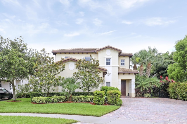 244 Behring Way, Jupiter, FL 33458 - mediterranean / spanish house with stucco siding, a tiled roof, and a front lawn