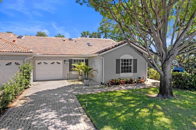 5160 Sabal Gardens Ln Unit 1, Boca Raton, FL 33487 - view of front facade featuring a garage, stucco siding, a front yard, a tiled roof, and decorative driveway