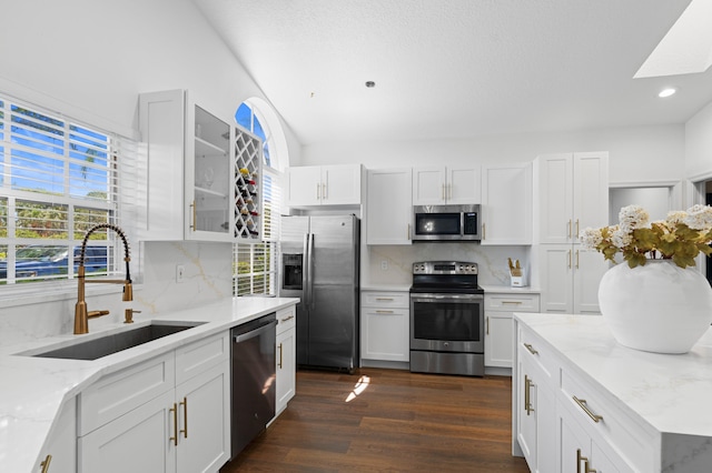 5160 Sabal Gardens Ln Unit 1, Boca Raton, FL 33487 - kitchen with appliances with stainless steel finishes, healthy amount of natural light, glass insert cabinets, decorative backsplash, and recessed lighting