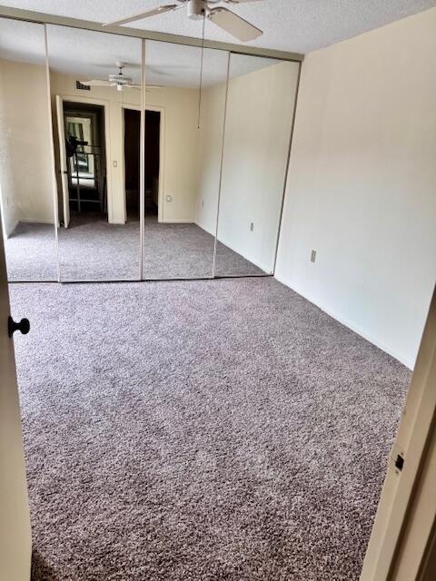 217 Live Oak Ln, Boynton Beach, FL 33436 - unfurnished bedroom featuring carpet floors and a textured ceiling