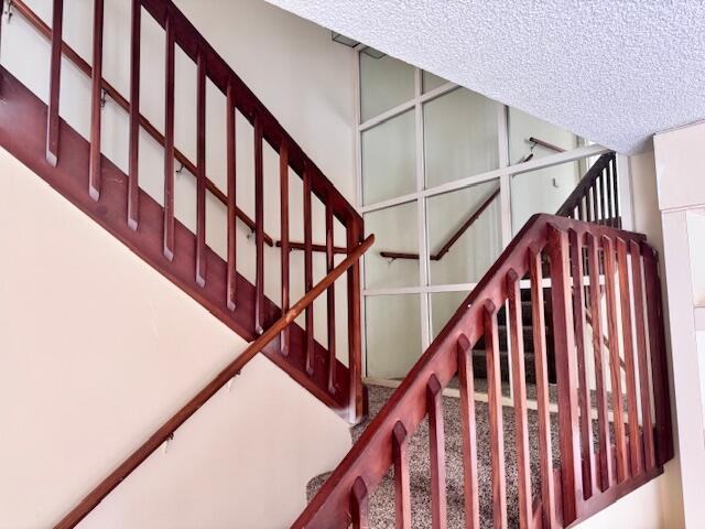 217 Live Oak Ln, Boynton Beach, FL 33436 - staircase with a textured ceiling