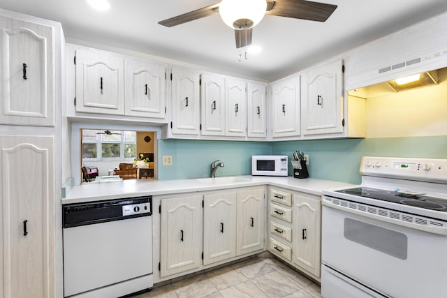 2600 NE 1st Ln Unit 3110, Boynton Beach, FL 33435 - kitchen with white appliances, ceiling fan, light countertops, white cabinets, and exhaust hood