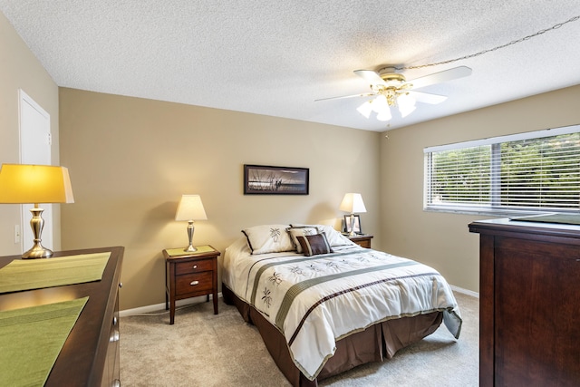 2600 NE 1st Ln Unit 3110, Boynton Beach, FL 33435 - bedroom with light colored carpet, a textured ceiling, and a ceiling fan