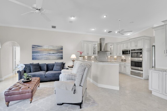 12388 Lakeridge Falls Dr, Boynton Beach, FL 33437 - living area featuring a ceiling fan, arched walkways, light tile patterned flooring, ornamental molding, and recessed lighting