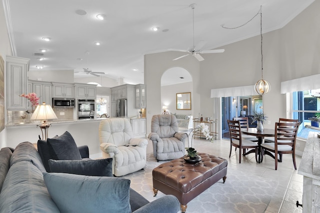 12388 Lakeridge Falls Dr, Boynton Beach, FL 33437 - living room with ceiling fan, vaulted ceiling, ornamental molding, healthy amount of natural light, and arched walkways