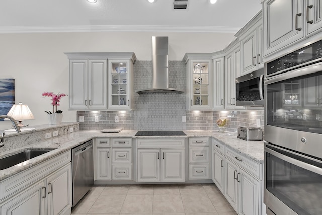 12388 Lakeridge Falls Dr, Boynton Beach, FL 33437 - kitchen with appliances with stainless steel finishes, wall chimney exhaust hood, ornamental molding, light tile patterned floors, and tasteful backsplash