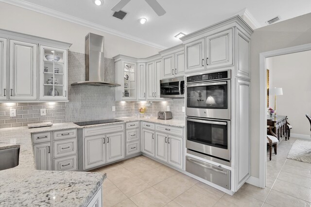 12388 Lakeridge Falls Dr, Boynton Beach, FL 33437 - kitchen featuring stainless steel appliances, wall chimney range hood, a warming drawer, light tile patterned floors, and ornamental molding