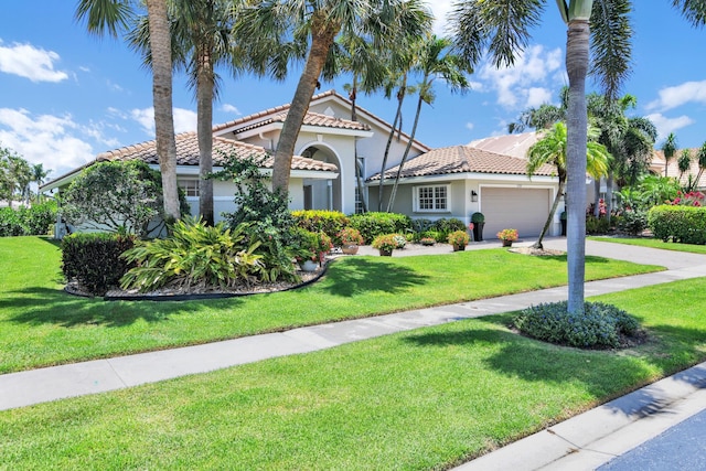 12388 Lakeridge Falls Dr, Boynton Beach, FL 33437 - mediterranean / spanish home with a tiled roof, stucco siding, an attached garage, and a front yard