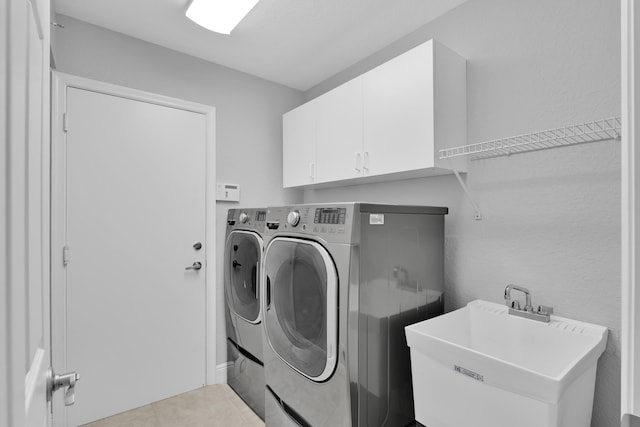 12388 Lakeridge Falls Dr, Boynton Beach, FL 33437 - laundry area with cabinet space, washer and clothes dryer, and light tile patterned floors