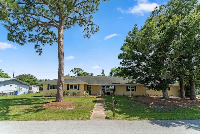 1144 NW 12th Ter, Stuart, FL 34994 - ranch-style home with a front yard and stucco siding