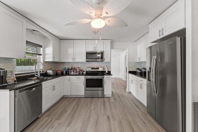 1144 NW 12th Ter, Stuart, FL 34994 - kitchen with appliances with stainless steel finishes, light wood-style floors, and dark countertops