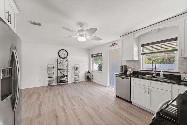 1144 NW 12th Ter, Stuart, FL 34994 - kitchen with appliances with stainless steel finishes, light wood-style flooring, decorative backsplash, and a ceiling fan