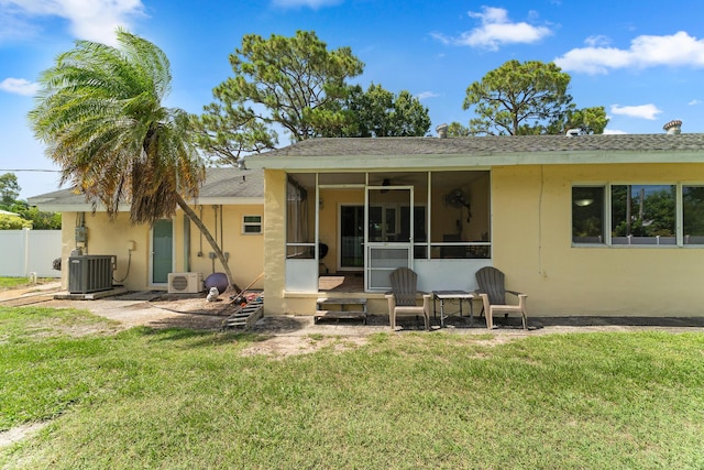 1144 NW 12th Ter, Stuart, FL 34994 - rear view of property featuring a sunroom, stucco siding, and roof with shingles