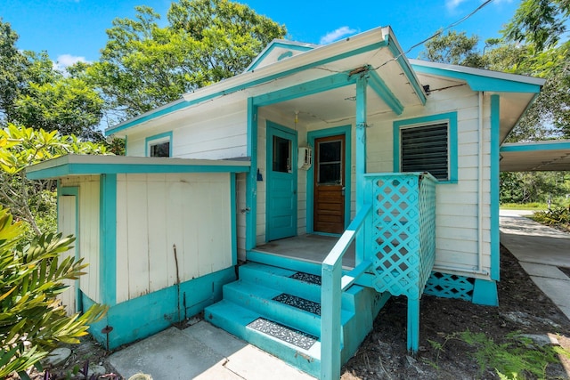 2302 Cortez Blvd, Fort Pierce, FL 34982 - entrance to property featuring a carport and a wall mounted air conditioner