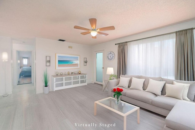 325 SE Bayview Ter, Port Saint Lucie, FL 34983 - living room with a textured ceiling, ceiling fan, and wood finished floors