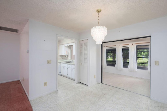 325 SE Bayview Ter, Port Saint Lucie, FL 34983 - unfurnished dining area with a chandelier and a textured ceiling