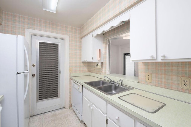 325 SE Bayview Ter, Port Saint Lucie, FL 34983 - kitchen with white appliances, light countertops, white cabinetry, and wallpapered walls