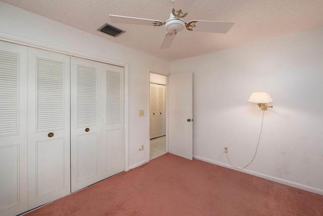 325 SE Bayview Ter, Port Saint Lucie, FL 34983 - unfurnished bedroom featuring light colored carpet, a closet, a ceiling fan, and a textured ceiling