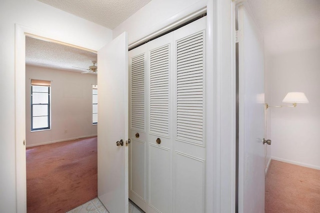 325 SE Bayview Ter, Port Saint Lucie, FL 34983 - hallway featuring light carpet and a textured ceiling