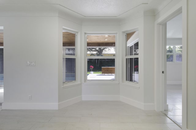 334 SW 14 Th Ave, Boynton Beach, FL 33435 - spare room featuring light tile patterned floors and a textured ceiling