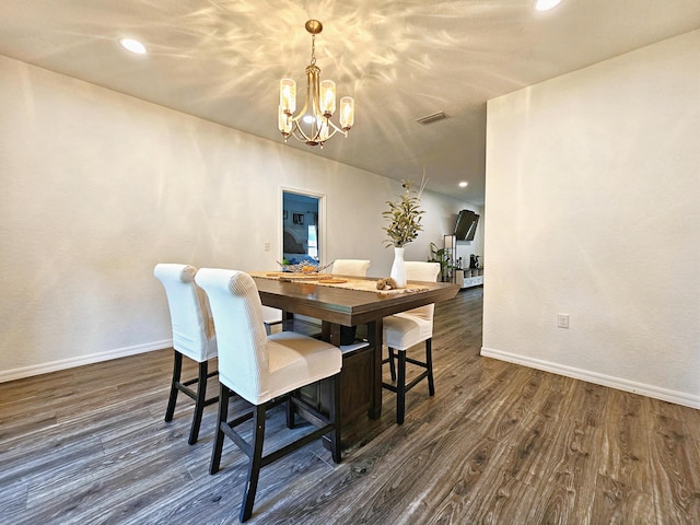 690 NE 150th Ct, Morriston, FL 32668 - dining space featuring a chandelier, dark wood finished floors, recessed lighting, and arched walkways