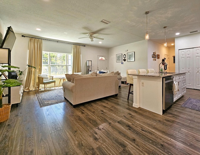 690 NE 150th Ct, Morriston, FL 32668 - living area featuring dark wood finished floors, a textured ceiling, a ceiling fan, and recessed lighting