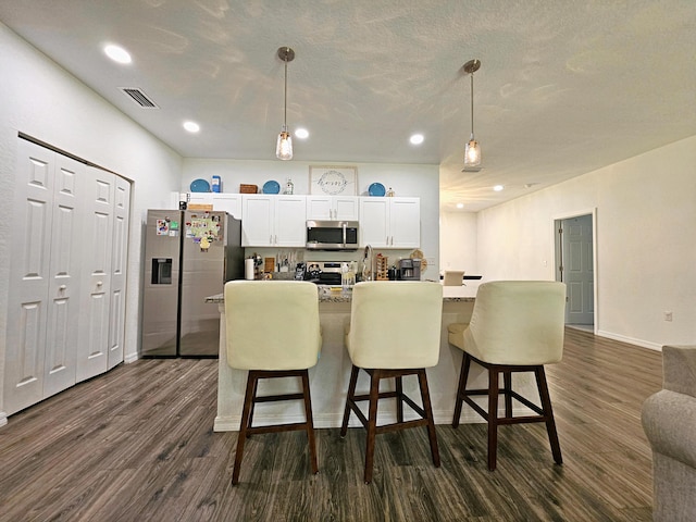 690 NE 150th Ct, Morriston, FL 32668 - kitchen with stainless steel appliances, dark wood-style floors, white cabinets, recessed lighting, and pendant lighting