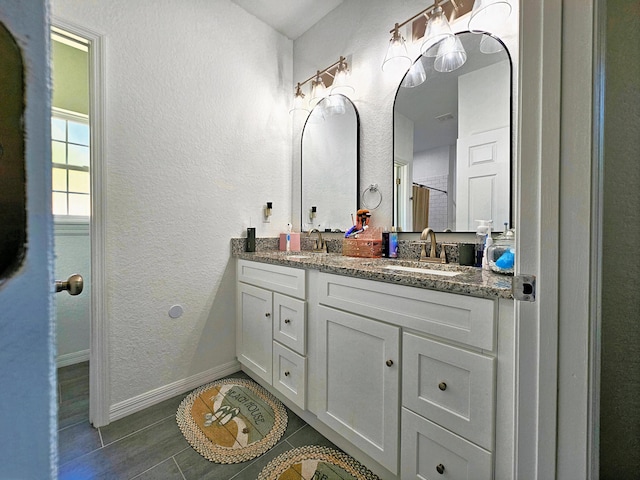 690 NE 150th Ct, Morriston, FL 32668 - bathroom with double vanity and a textured wall