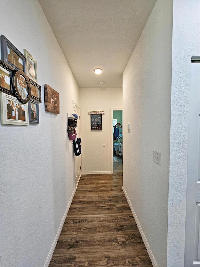 690 NE 150th Ct, Morriston, FL 32668 - corridor featuring a textured wall, dark wood-type flooring, and a textured ceiling