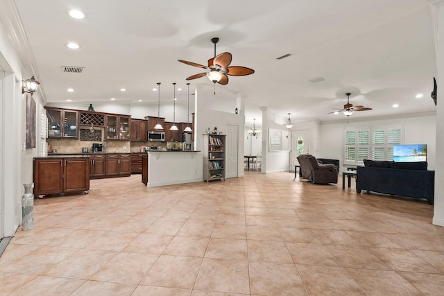 468 SW Prado Ave, Port Saint Lucie, FL 34983 - kitchen featuring open floor plan, stainless steel microwave, a ceiling fan, dark countertops, and ornamental molding