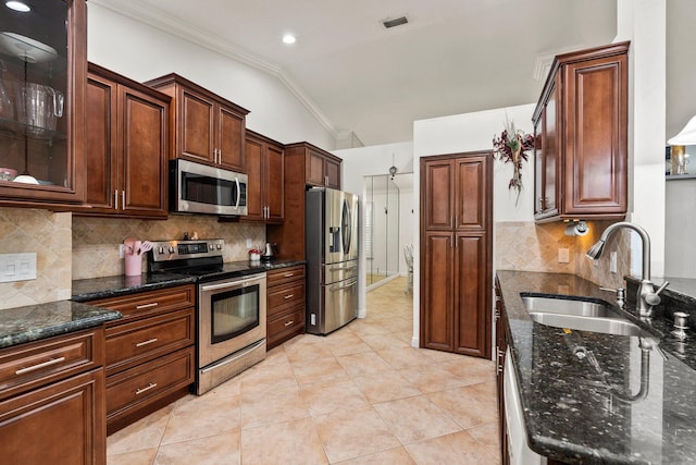 468 SW Prado Ave, Port Saint Lucie, FL 34983 - kitchen featuring stainless steel appliances, ornamental molding, dark stone countertops, decorative backsplash, and light tile patterned floors