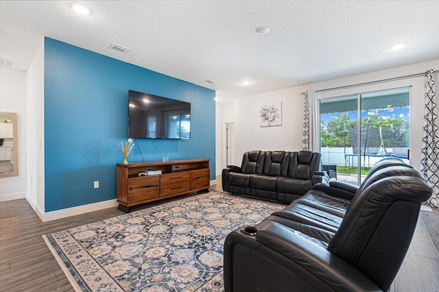 5371 NW Almond Ave, Port Saint Lucie, FL 34986 - living room featuring a textured ceiling, wood finished floors, and recessed lighting