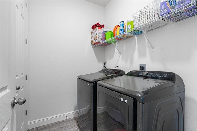 5371 NW Almond Ave, Port Saint Lucie, FL 34986 - laundry area with washer and clothes dryer and wood finished floors