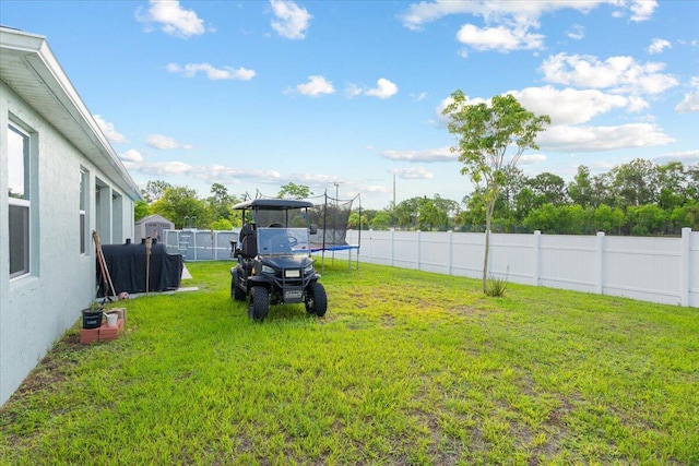 5371 NW Almond Ave, Port Saint Lucie, FL 34986 - fenced backyard featuring a trampoline and a detached carport