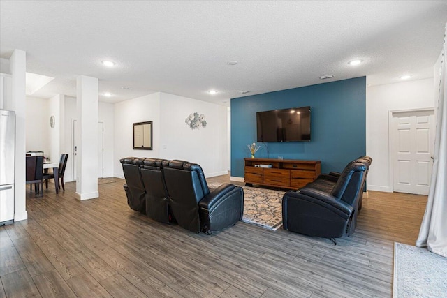 5371 NW Almond Ave, Port Saint Lucie, FL 34986 - living area featuring recessed lighting, wood finished floors, and a textured ceiling